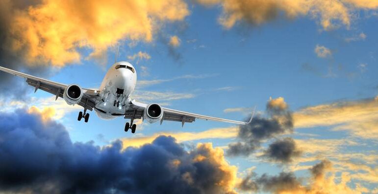 Panorama of airplane in sunset sky