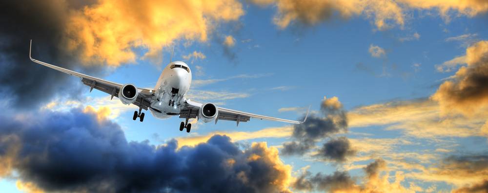 Panorama of airplane in sunset sky